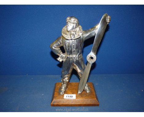 An appealing highly polished metal table/hearth lighter in the form of an airman in a flying suit, helmet and goggles support