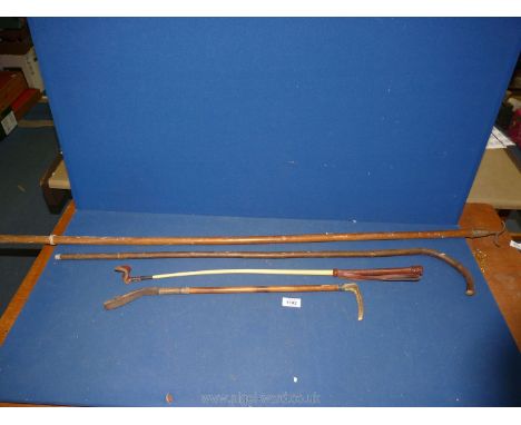 Two riding whips, one having Antler handle, a walking stick and a wooden window hook.