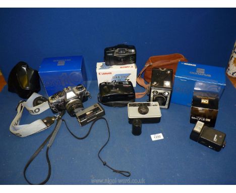 A quantity of cameras including Brownie Six - 20 model C in a case, two boxed Olympus OM , Kodak Mini Instamatic S30 , Olympu