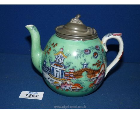 An interesting early-mid Victorian small Teapot, transfer printed and painted with colourful pagodas against a turquoise grou