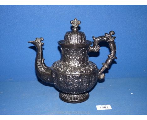 An impressive late Georgian Jackfield black Teapot and cover, elaborately moulded with Prince of Wales feathers surmount to t