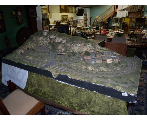 An 'N' gauge model railway Diorama scene, 6' x 3' and made of polystyrene using Woodland Scenics kit including buildings and 