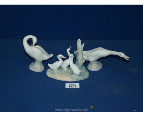 Two Lladro geese and a Nao figure of three ducks.