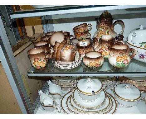 A Carlton Ware part tea and coffee service with embossed brown and floral pattern:coffee and teapots, mugs, cups, saucers, et