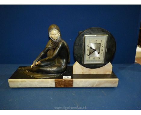 An elegant Art Deco design mantel clock of contrasting coloured stone and featuring a reclining lady in a stylish dress and w