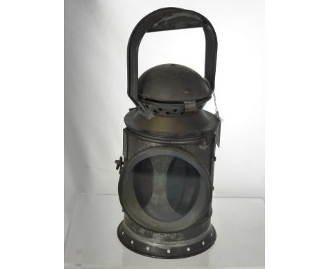 An Antique Train Signal Lantern, the lantern having green and red glass.