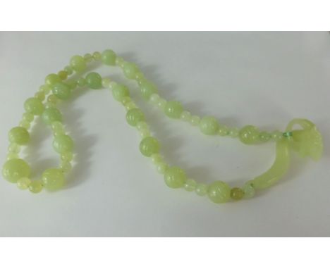 An Apple Green Jade Beaded Necklace, the carved necklace having a dragon form clasp, approx 60 cms long.