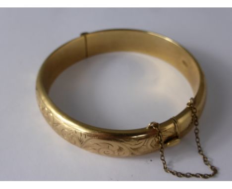 A Lady's 375 9 ct Gold Bangle, the bangle having floral decorations, approx wt 20 gms.