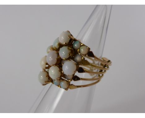 A Lady's 14 ct Gold and Opal Dress Ring, each individual ring is joined at the base with fine wire, to create an overall clus