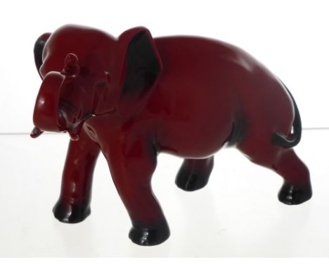 A Royal Worcester Flambe Porcelain  Figure in the form of an Elephant, approx 20 cms long x 7 cms high.