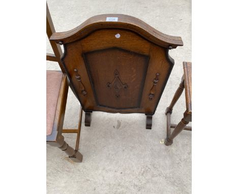 AN EARLY 20TH CENTURY OAK FIRESCREEN WITH APPLIED DECORATION 