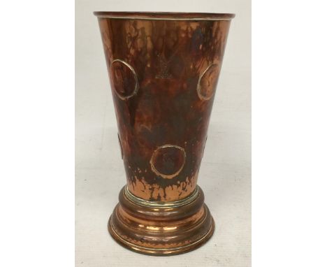 A VINTAGE COPPER GAMBLING TAVERN DICE SHAKING BEAKER EMBEDDED WITH COINS AND DICE BENEATH A GLASS BASE WITH STAG MAKERS MARK 