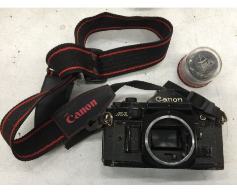 A VINTAGE CANON A-1 CAMERA WITH LENS 