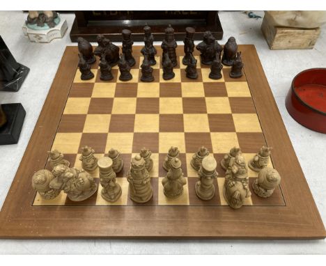 A CHESS SET WITH A WOODEN BOARD AND ALICE IN WONDERLAND THEMED PLAYING PIECES 
