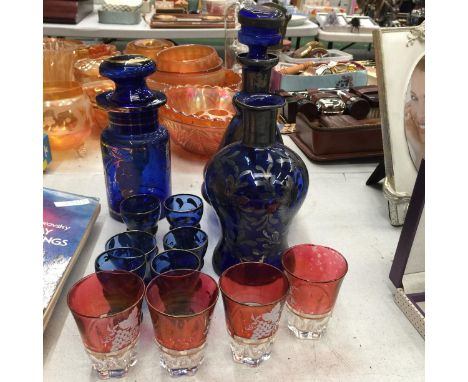 A VINTAGE BLUE GLASS WITH GILT DECORATION DECANTER, STORAGE JAR, VASE AND GLASSES PLUS FOUR CRANBERRY WITH GILT DECORATION GL
