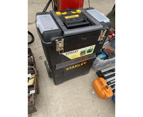A PLASTIC STANLEY STACKING TOOL BOX WITH TROLLEY WHEELS AND AN ASSORTMENT OF TOOLS TO INCLUDE FILES, HAMMERS AND WIRE BRUSHES