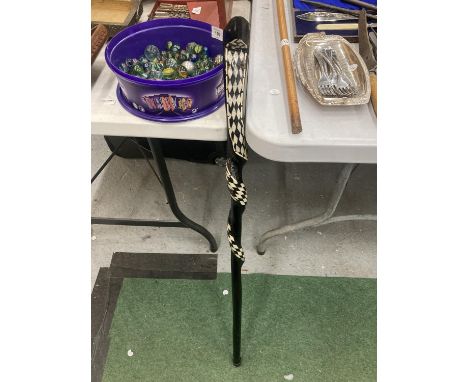 A WOODEN TWISTED SNAKE WALKING STICK WITH INLAID MOTHER OF PEARL 