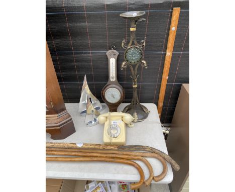 AN ASSORTMENT OF ITEMS TO INCLUDE WALKING STICKS, A ROTARY DIAL TELEPHONE AND A CANDLESTICK ETC 