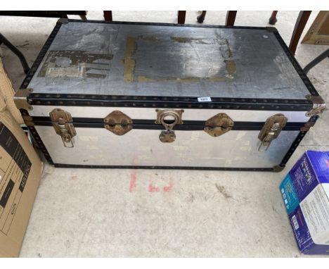 A LARGE HARD CASED TRAVEL TRUNK 