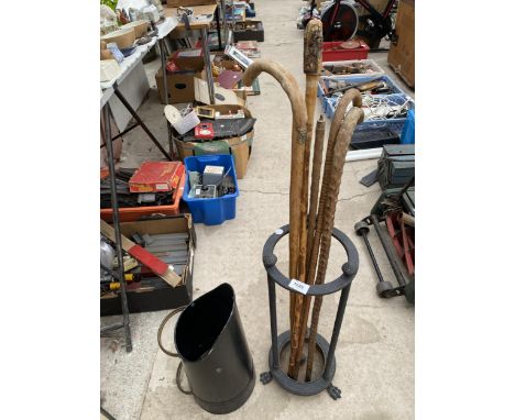 A VINTAGE STICK STAND WITH LION PAW FEET, AN ASSORTMENT OF WALKING STICKS AND A COAL SKUTTLE ETC 