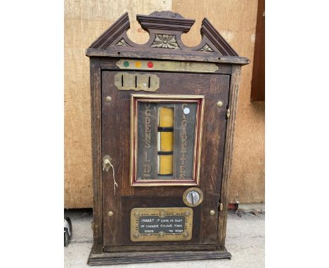 A VINTAGE WOODEN BUZZOS CIGARETTE MACHINE 