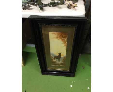 A VINTAGE EBONY STLYE FRAMED HIGHLAND PRINT OF A STAG 