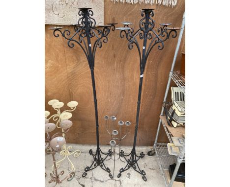 A PAIR OF TALL WROUGHT IRON FOUR BRANCH CANDLE STICKS (H:172CM) AND A FURTHER LOW METAL SIX BRANCH CANDLESTICK 
