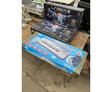 A CASIO KEYBOARD AND TWO LASERX GAMES 