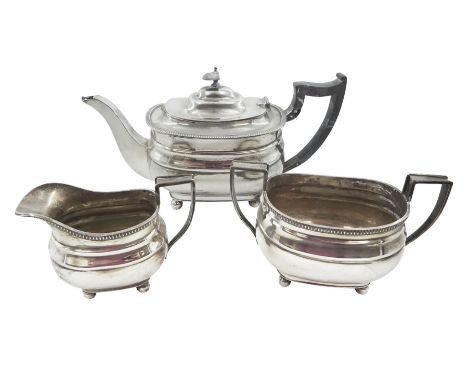 1930s silver three piece tea service, comprising teapot, open sucrier and milk jug, each of oval form with oblique gadrooned 