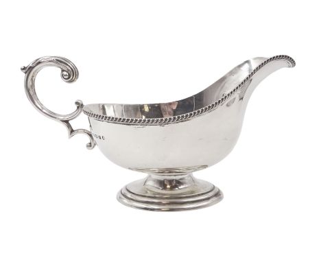 1930s silver sauce boat, of typical form, with oblique gadrooned rim and acanthus capped flying C scroll handle, by William H