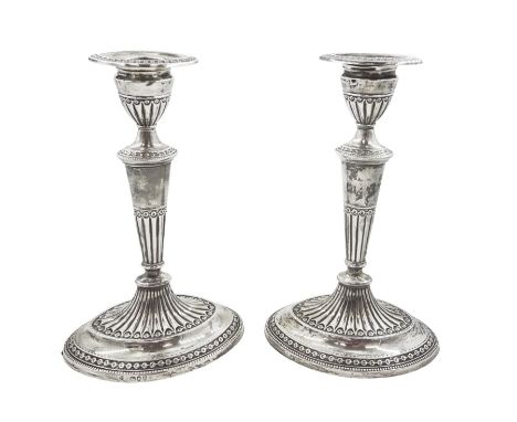 Pair of late Victorian silver mounted candlesticks, each of oval form, with tapering stem and removable sconce, upon an oval 