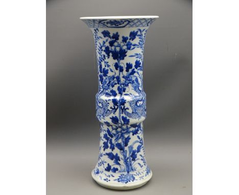 LARGE BLUE &amp; WHITE ORIENTAL GU SHAPED VASE depicting two dragons on a floral background, 35cms H, Kangxi marks to the bas
