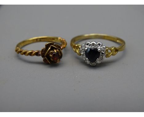 TWO NINE CARAT GOLD RINGS, one of sapphire and diamonds heart shape, the other of ruby flower form setting, 3.9grms total