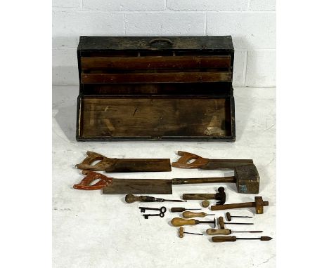 A vintage wooden tool chest marked E.D, with a small selection of woodworking tools. 