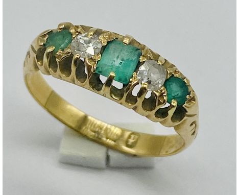 An 18ct gold emerald and diamond 5 stone ring