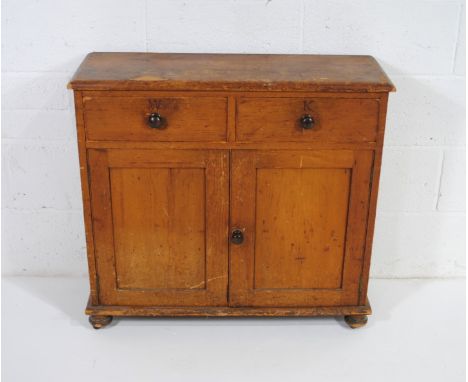 An antique pine narrow dresser base with two drawers stamped 'W' and 'K' and cupboard under - length 83.5cm, depth 29cm, heig