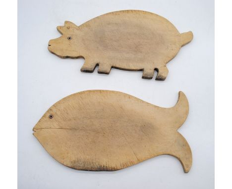 Two vintage wooden bread boards, in the form of a pig and a fish