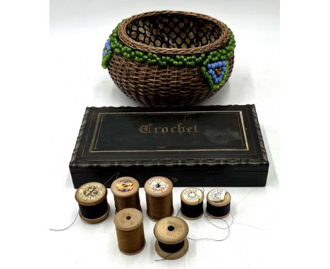 A vintage ebonised Crotchet box along with a wicker sewing basket and various cotton reels.