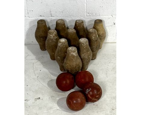 A vintage set of ten wooden skittles along with four rubber skittle balls 