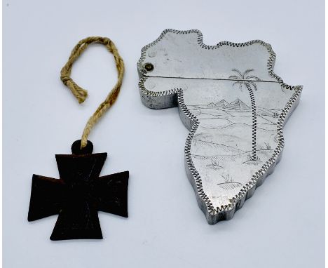 A vintage "Souvenir of Egypt" lighter in the form of a map of Africa along with a small iron cross with feint writing (name?)