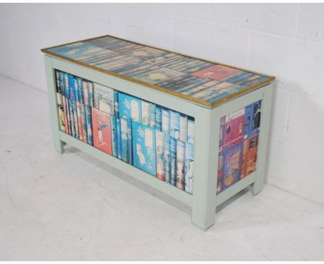 A painted ottoman, decorated with pictures of vintage books - length 104cm, depth 42cm, height 55cm