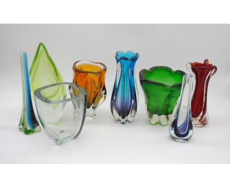A collection of eight art glass vases, including a Murano Sommerso ribbed blue vase, a red Vertrarti vase, a yellow vase by J