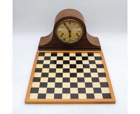 A vintage mantel clock, along with a chess board