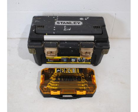 A Stanley tool box containing various ratchet & socket sets, along with a boxed DeWalt socket set