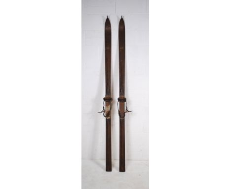 A pair of vintage wooden skis, marked 'J. E. H.'