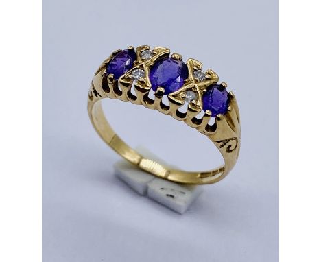 A 9ct gold amethyst ring with diamond insets