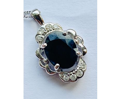 A sapphire and diamond pendant set in 9ct white gold on chain