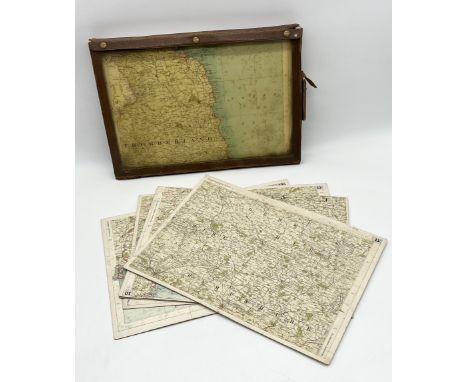 A collection of vintage motoring maps mounted on board contained within a leather case 