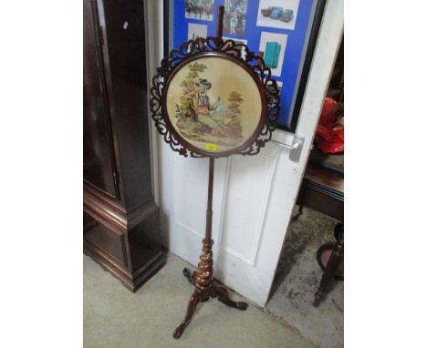 A 19th century rosewood pole-screen having a tapestry surrounded by pierced fretwork, turned and spiral column and on three c