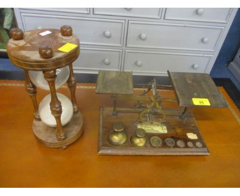 A gilt metal inlaid letter scales on wooden base with brass weights and a wooden hourglass  timer 